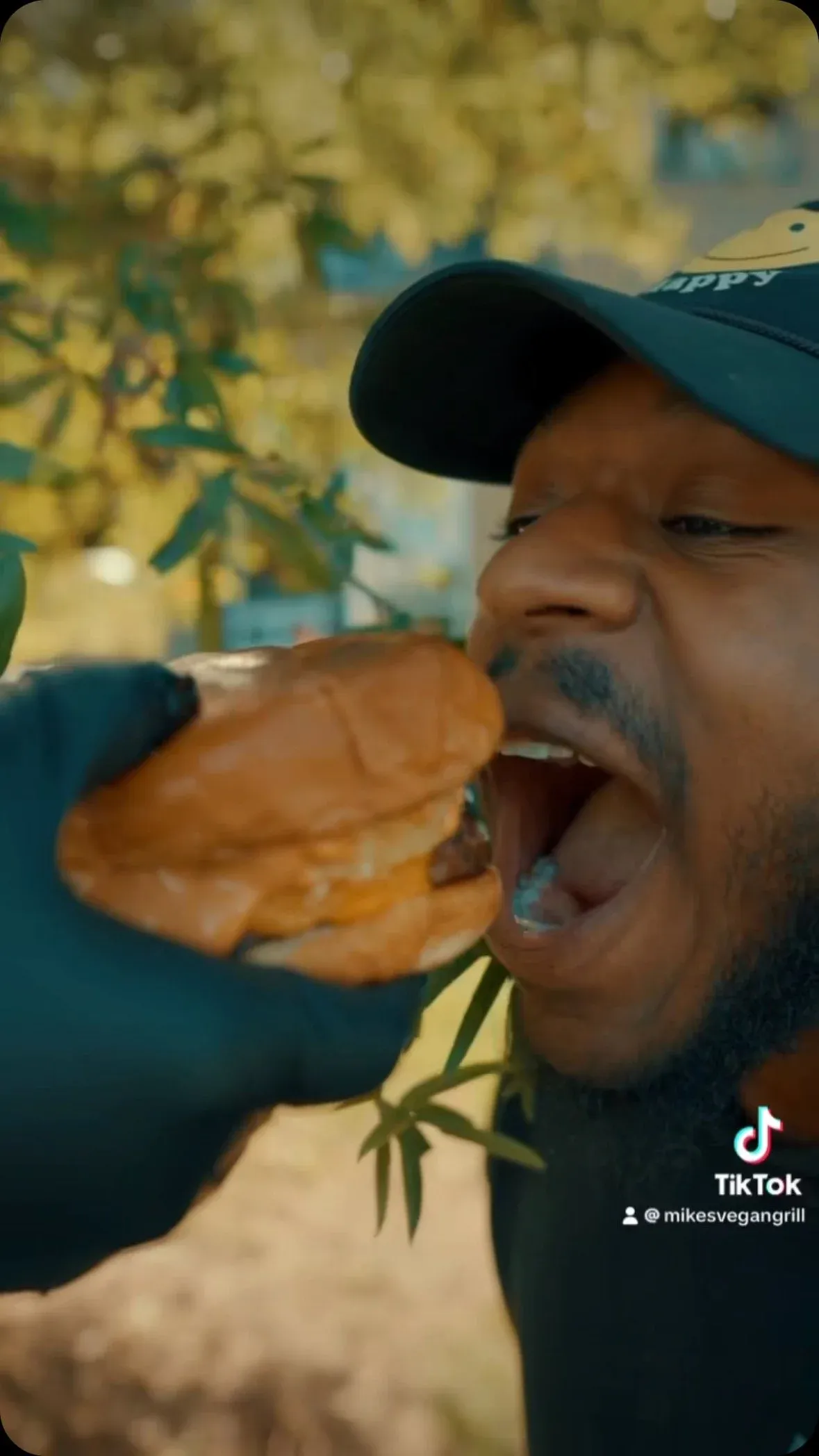 A customer biting into a Mike’s vegan burger